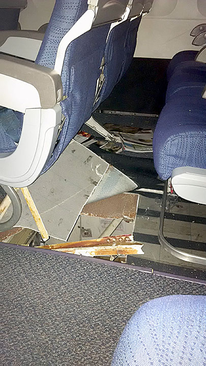 Photo of the damage to floor at row 31 seats D, E, F