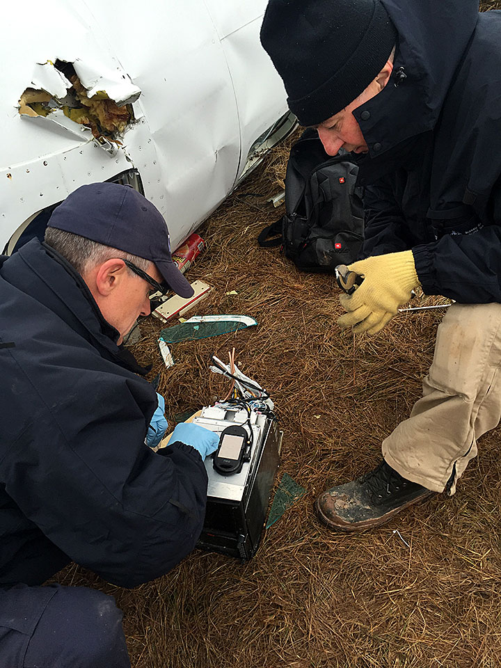 Image of TSB investigators examining the onboard recording device