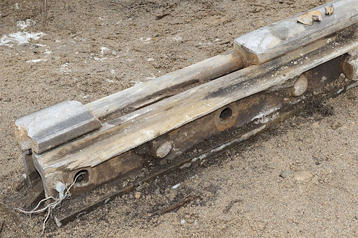 Image of a broken rail in joint bars and wheel flange damage to top of joint bar