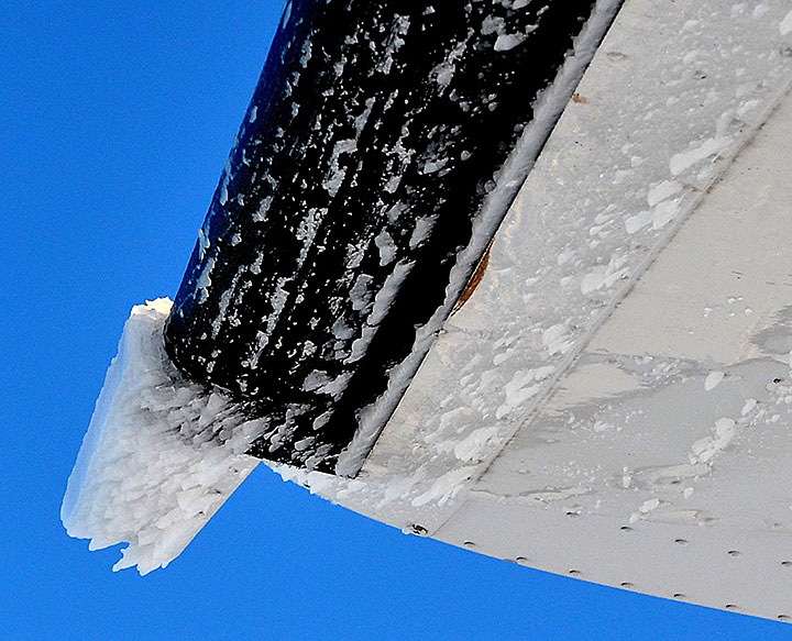 Ice accretion on the outer portion of the right horizontal stabilizer, and beneath and aft of the de-ice boot