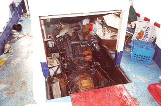 Photo of the opening in the main deck with no steel coaming in way of portable plywood panels of engine casing