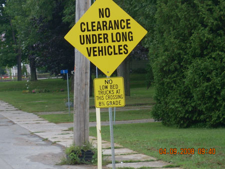 No clearance warning signs installed at and on the approach to the Quabbin Road crossing after the occurrence