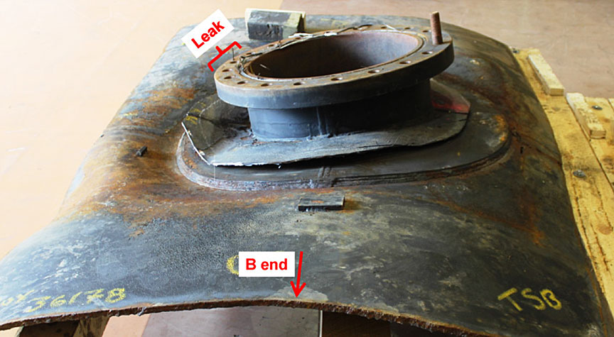Photograph taken after removing the tank jacket to expose the weld joining the manway nozzle reinforcement to the tank