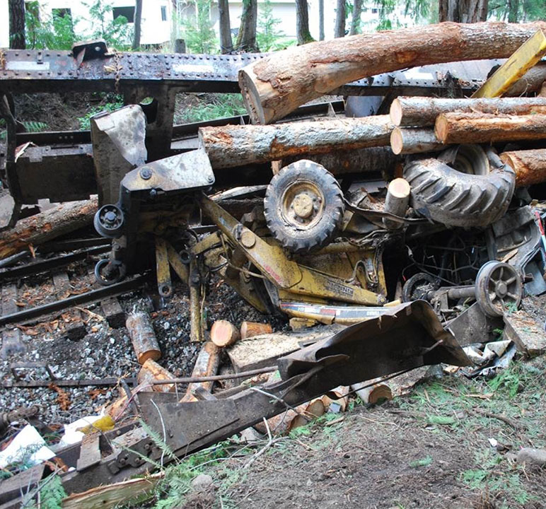 Second derailment location, showing the backhoe buried under logs