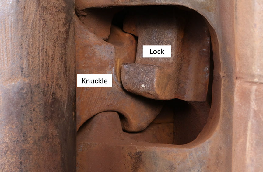 Subject coupler lock fully dropped and engaged with knuckle tail