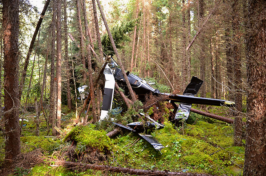 Wreckage of the Bell 206B helicopter in the woods 
