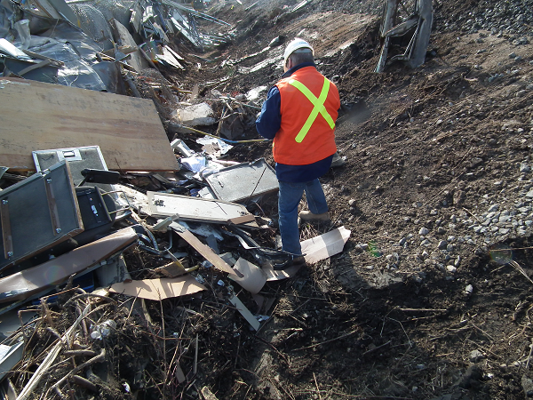 A TSB investigator documents debris at the occurrence site