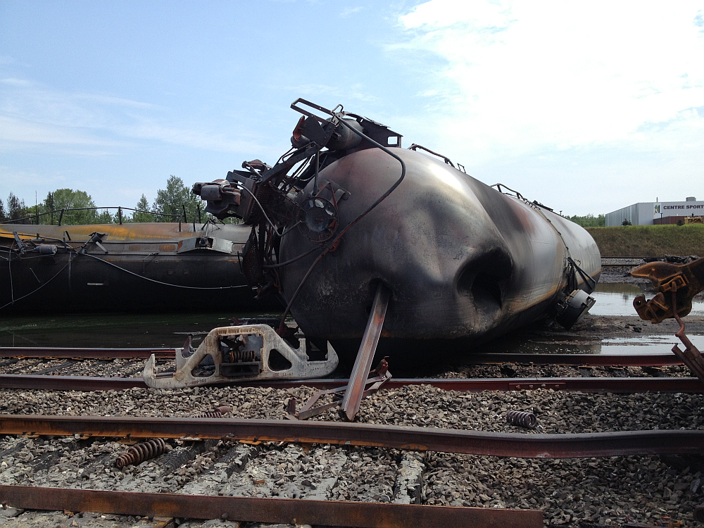 Overturned tank cars and twisted rails at Lac-Mégantic accident site