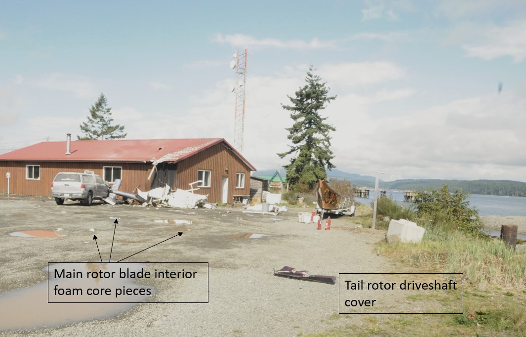 Photo of the accident site, taken 90 minutes after the accident, looking north along the direction of flight. The second truck that had been struck by the helicopter had already been moved when this photo was taken. (Source: Royal Canadian Mounted Police, with TSB annotations)