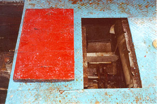 Photo of the hatch opening in main deck with no sealing gasket or means of securing flush wooden cover