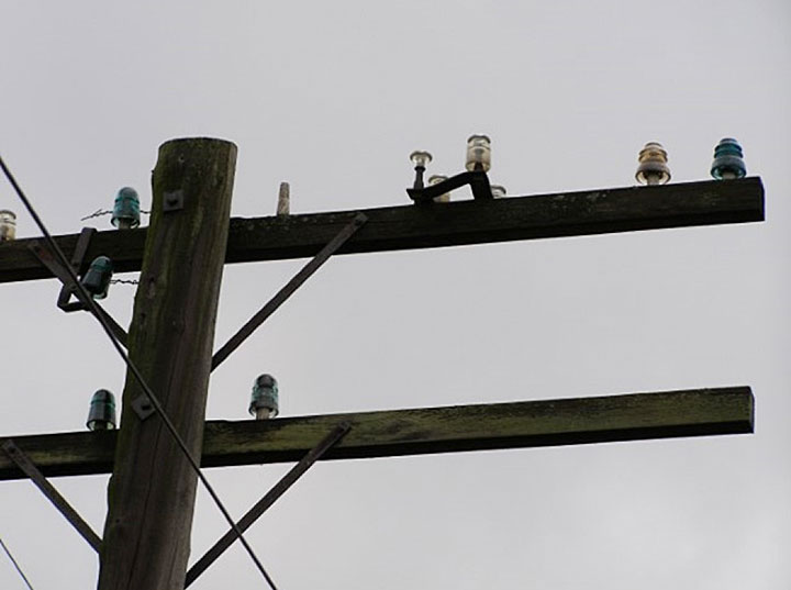Image of the coloured glass insulators on pole line