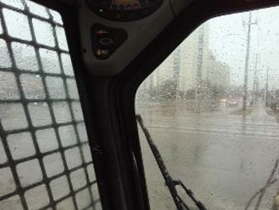   Photo taken from a driver's  seated eye position in the snowplow showing the view toward the northwest  quadrant of the crossing when the snowplow was positioned adjacent to the  southeast quadrant crossing warning system mast (the location of the snowplow  when the gates began to descend) (Source: TSB)<br>