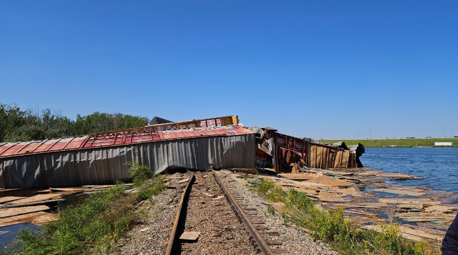 Several of the derailed cars came to rest across the railway right-of-way and extending into an adjacent body of water. (Source: Transportation Safety Board of Canada)